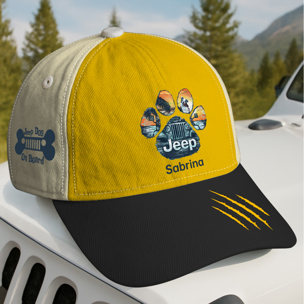 Yellow and beige cap with Jeep logo and paw print design on a car hood with a forest background