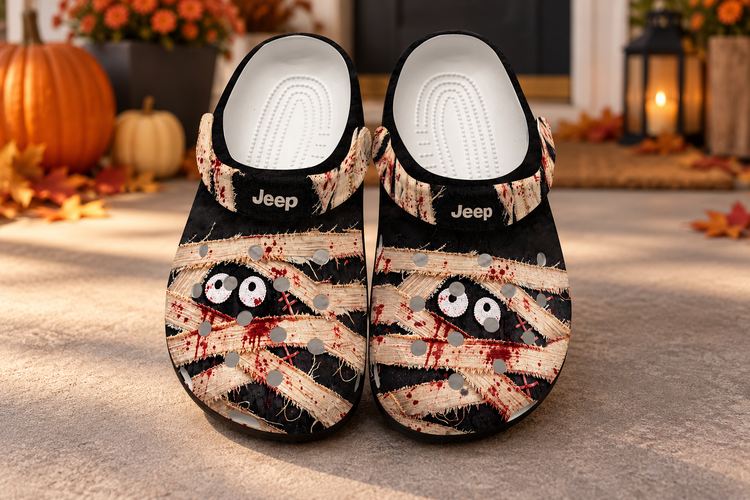 Black Jeep Mummy Clogs with printed bandage artwork on an autumn porch