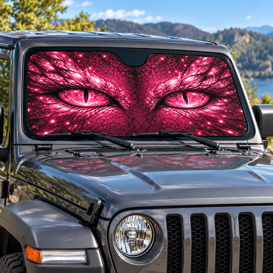 Pink flat printed dragon eyes sunshade in the windshield of a parked vehicle