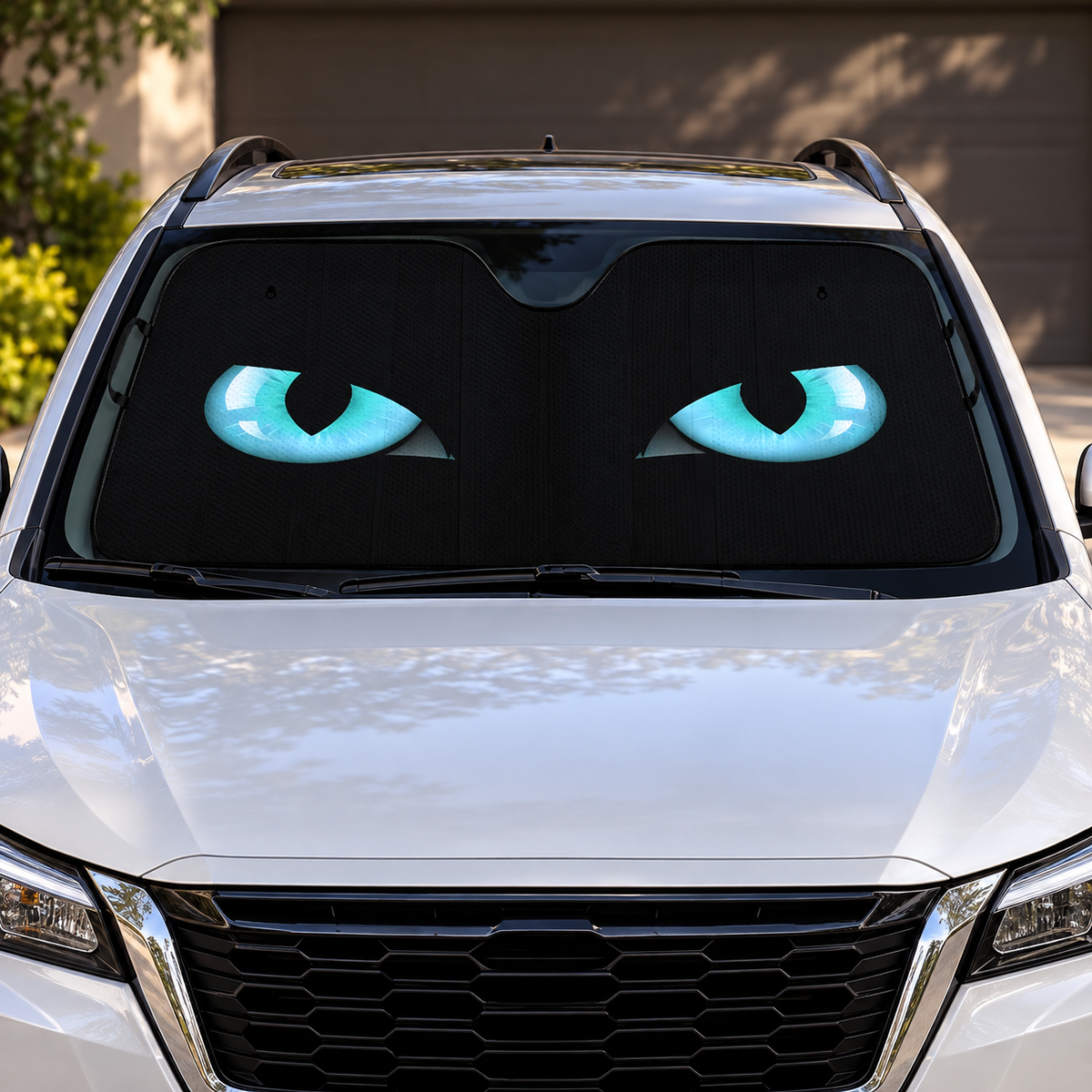 Cat Eyes Auto Sunshade with turquoise printed eyes in parked windshield